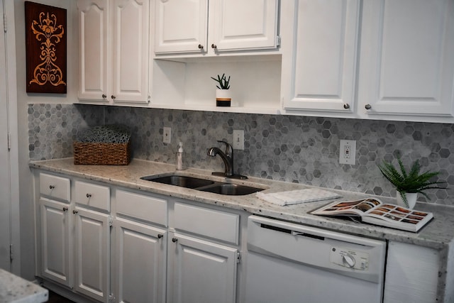 kitchen with white cabinets, decorative backsplash, dishwasher, and sink