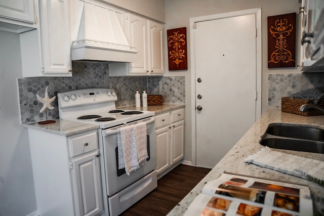 kitchen with white cabinets, premium range hood, white range with electric stovetop, and sink