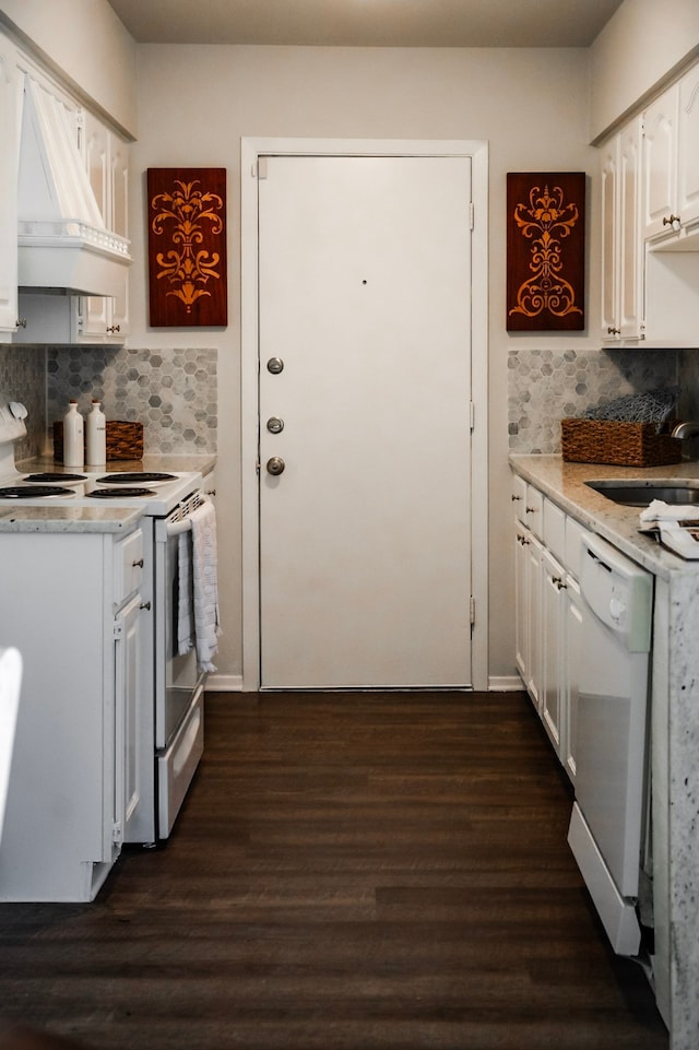 kitchen with sink, dark wood-type flooring, white appliances, decorative backsplash, and white cabinets