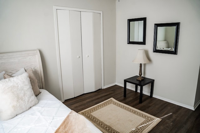 bedroom with dark hardwood / wood-style flooring and a closet