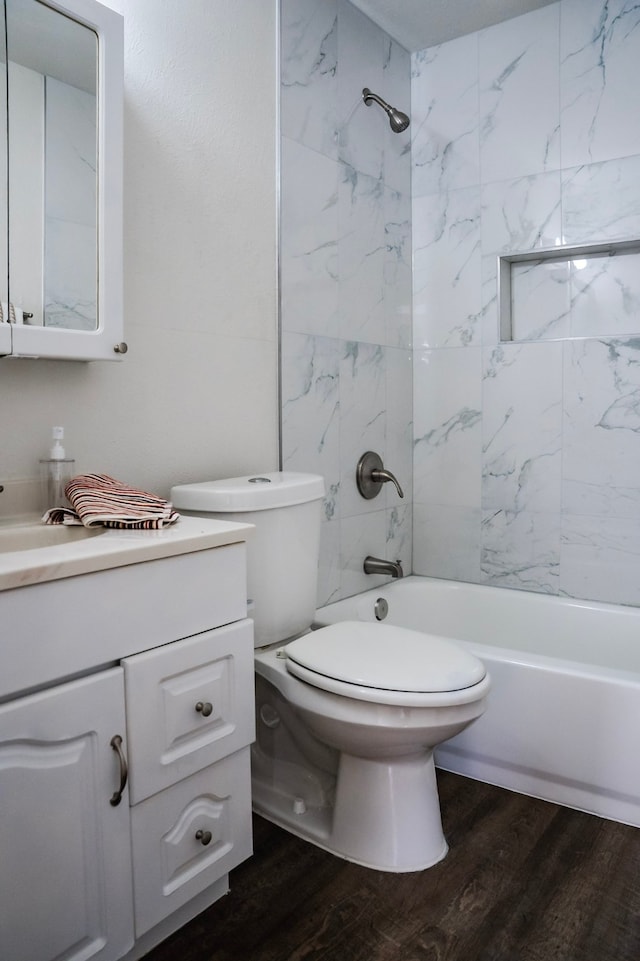 full bathroom with toilet, vanity, tiled shower / bath combo, and hardwood / wood-style flooring