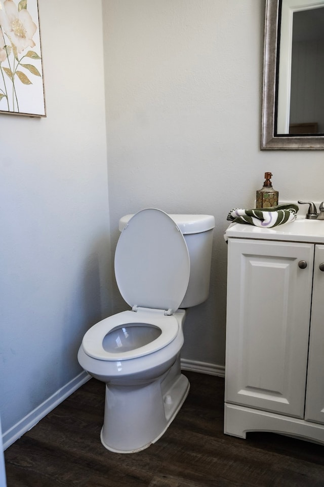 bathroom featuring hardwood / wood-style floors, vanity, and toilet