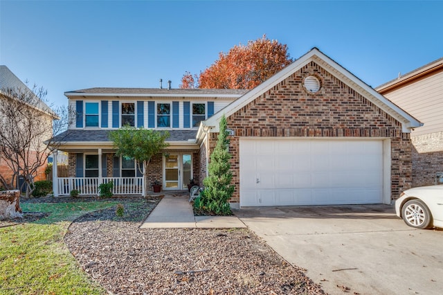 view of property with covered porch and a garage