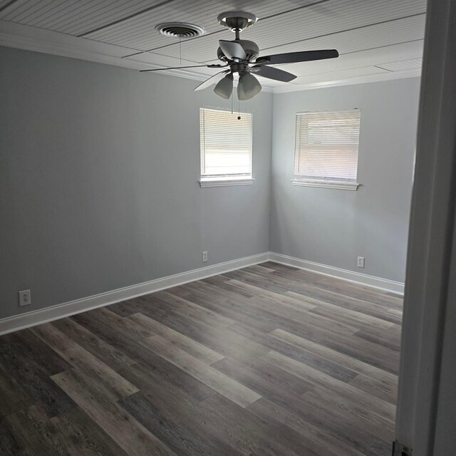 spare room featuring ornamental molding, ceiling fan, and dark wood-type flooring