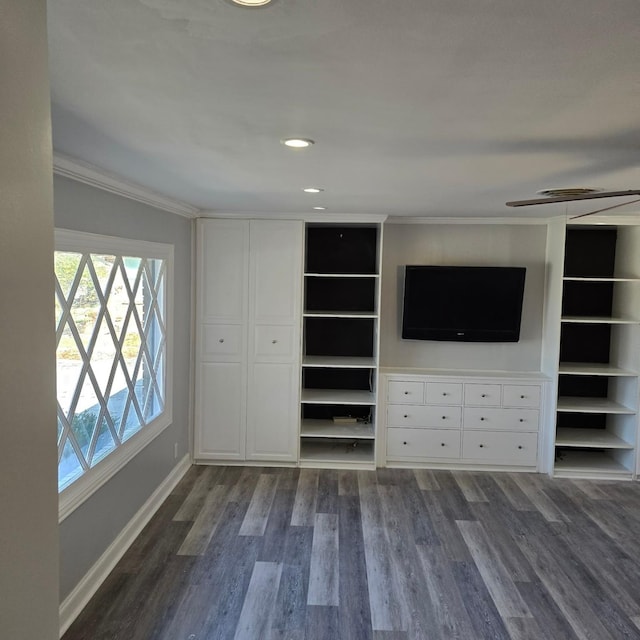 unfurnished living room featuring dark hardwood / wood-style floors, ceiling fan, and ornamental molding