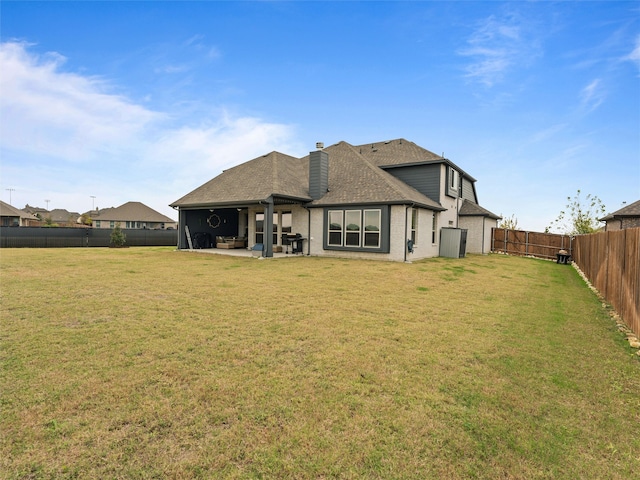 rear view of house featuring a patio and a lawn