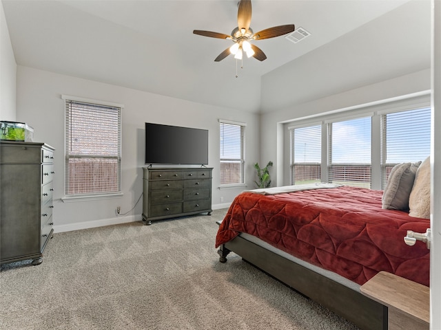 carpeted bedroom with ceiling fan and vaulted ceiling