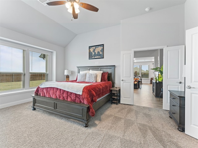 carpeted bedroom featuring ceiling fan and vaulted ceiling