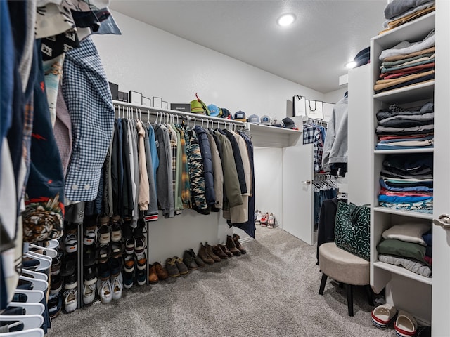 walk in closet with carpet