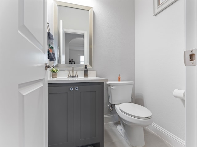 bathroom with tile patterned flooring, vanity, and toilet