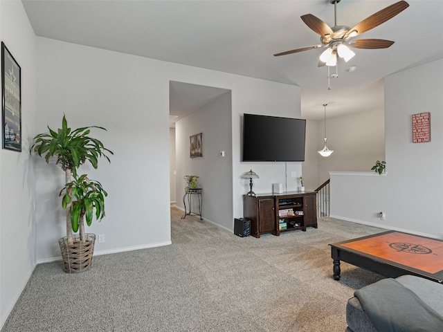 carpeted living room with ceiling fan