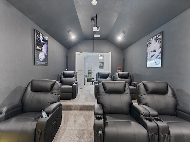 carpeted cinema room with lofted ceiling