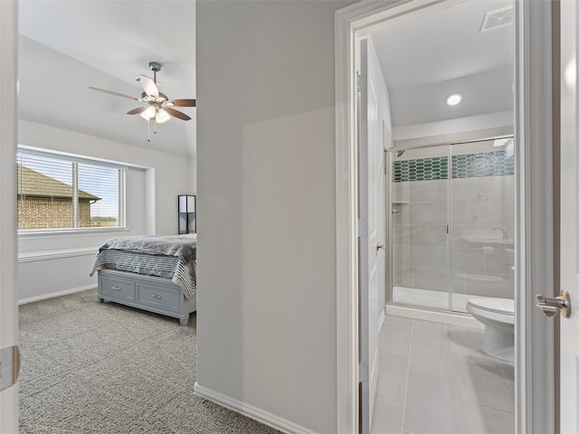 bathroom featuring tile patterned floors, ceiling fan, toilet, and a shower with door