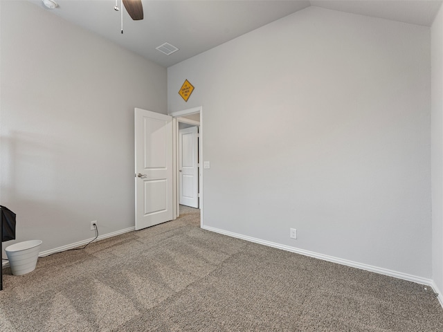 carpeted empty room with ceiling fan and vaulted ceiling