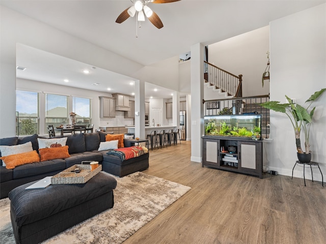 living room featuring ceiling fan and light hardwood / wood-style flooring