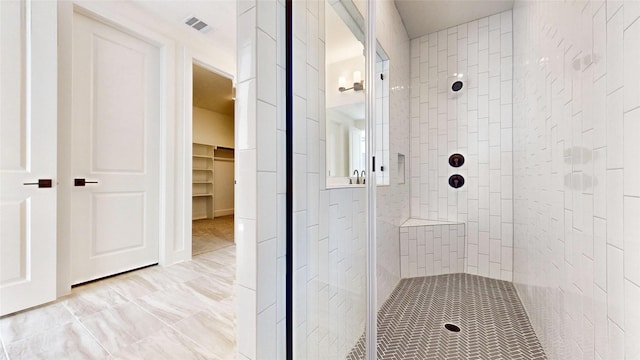 bathroom with a tile shower