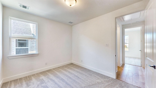 unfurnished room featuring a healthy amount of sunlight and light wood-type flooring