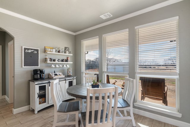 dining area with crown molding