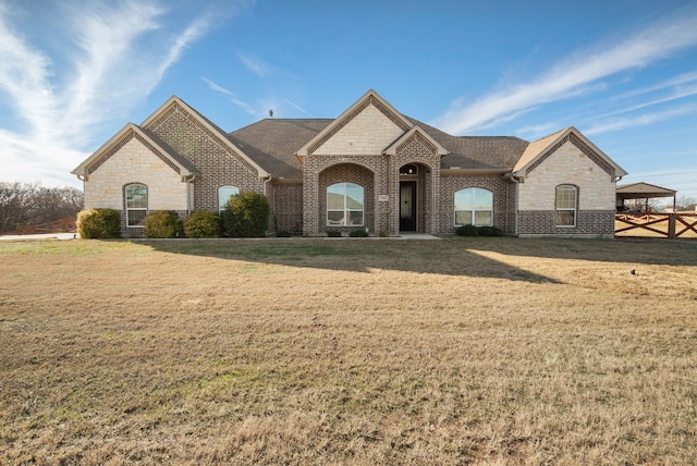 french country home with a carport and a front lawn