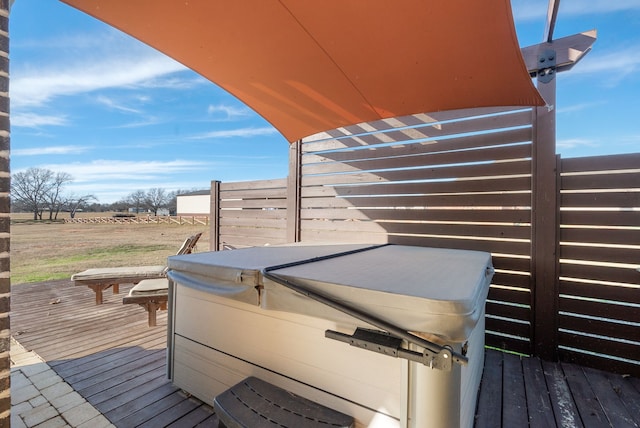 wooden deck featuring a hot tub