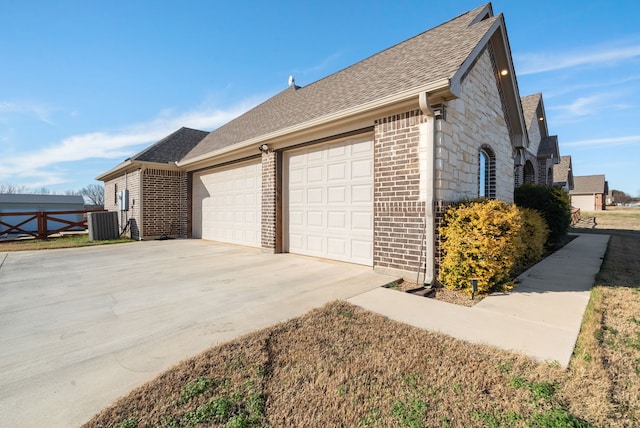 view of home's exterior featuring central AC unit and a garage