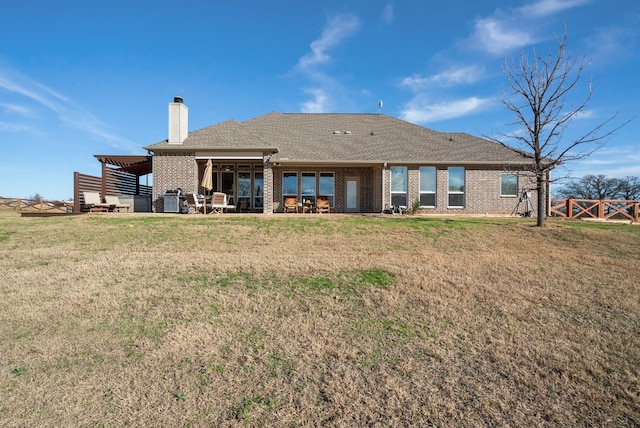 back of house featuring a lawn and a patio