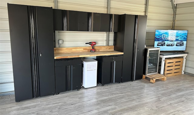 kitchen featuring light hardwood / wood-style flooring and beverage cooler