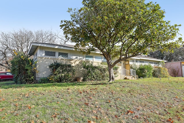 view of home's exterior with a yard