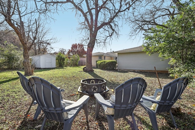 view of yard featuring a fire pit and a shed