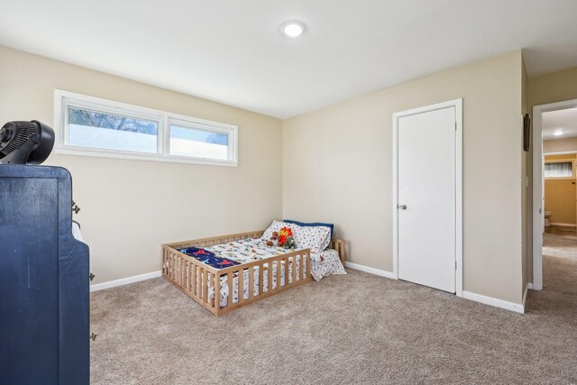 carpeted bedroom with ceiling fan, crown molding, and multiple windows