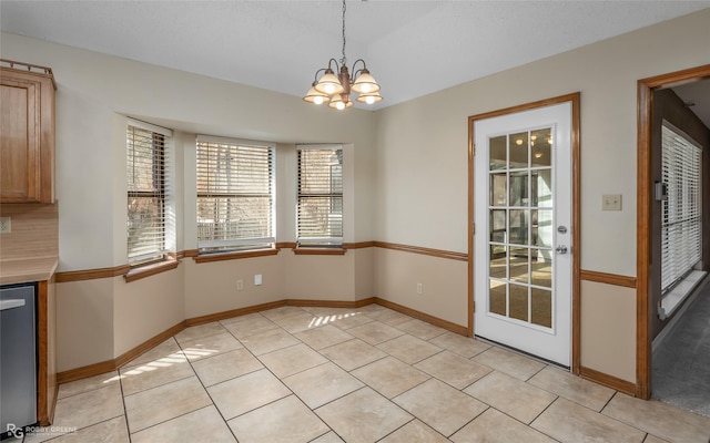 unfurnished dining area featuring a chandelier and light tile patterned floors