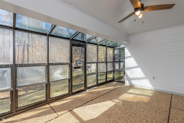 unfurnished sunroom with ceiling fan and plenty of natural light