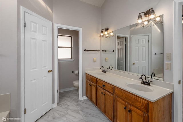 bathroom featuring vanity and toilet