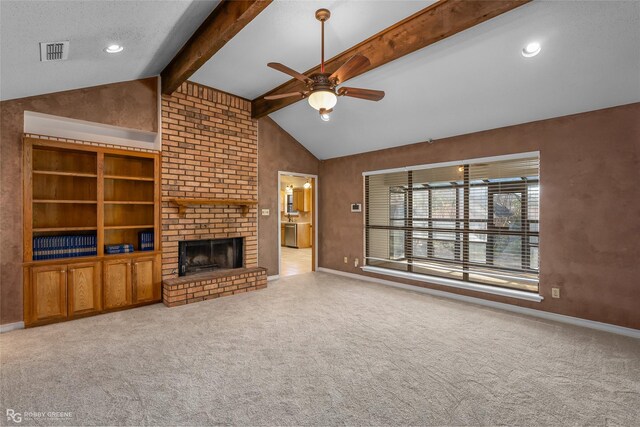 unfurnished living room featuring light carpet, vaulted ceiling with beams, ceiling fan, a textured ceiling, and a fireplace