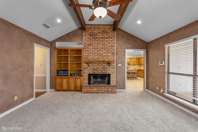 unfurnished living room featuring lofted ceiling with beams, ceiling fan, light colored carpet, and a fireplace