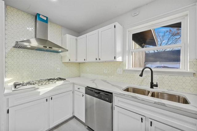 kitchen with backsplash, wall chimney exhaust hood, sink, dishwasher, and white cabinetry