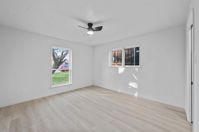 spare room with ceiling fan and light wood-type flooring