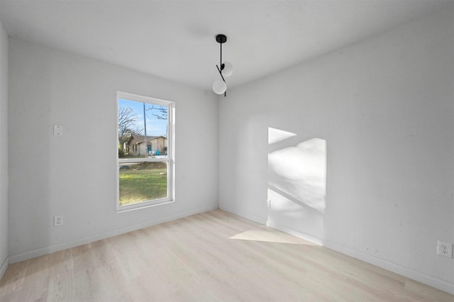 empty room with light hardwood / wood-style flooring