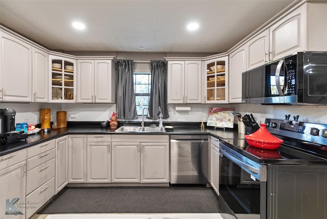 kitchen with sink, white cabinets, stainless steel dishwasher, and black range with electric cooktop