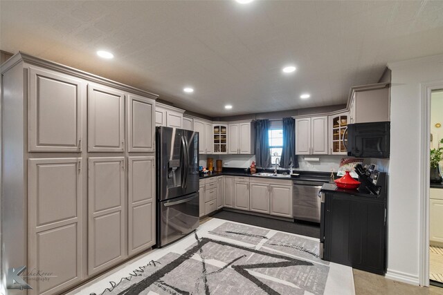 kitchen featuring black appliances, gray cabinets, and sink