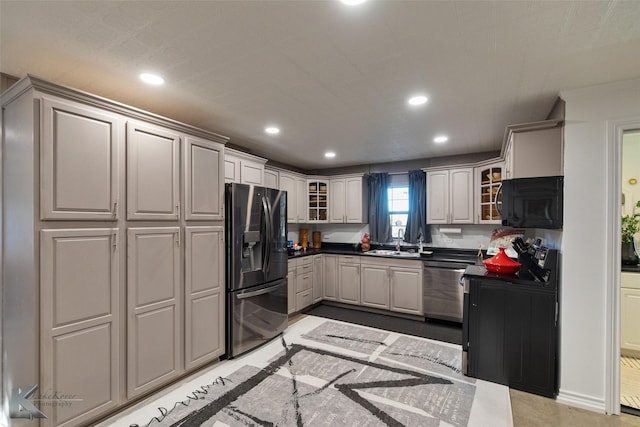 kitchen featuring stainless steel appliances, sink, and gray cabinetry