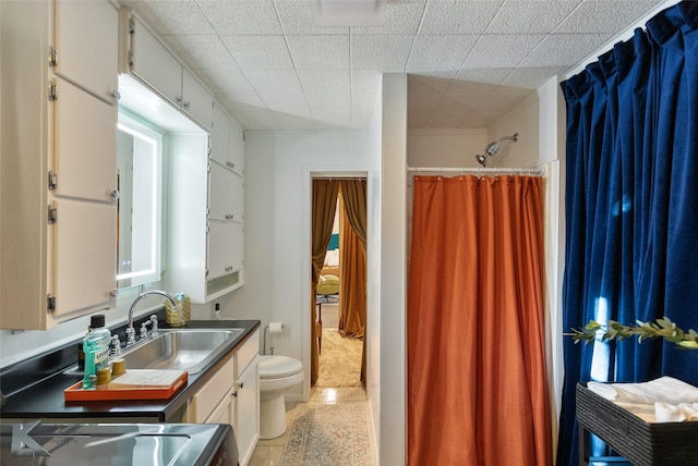 bathroom featuring tile patterned floors, vanity, curtained shower, and toilet