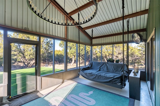 sunroom with a healthy amount of sunlight and vaulted ceiling