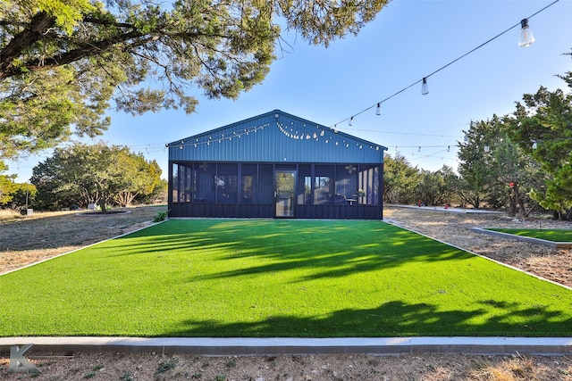 view of front of house with a front lawn and a sunroom