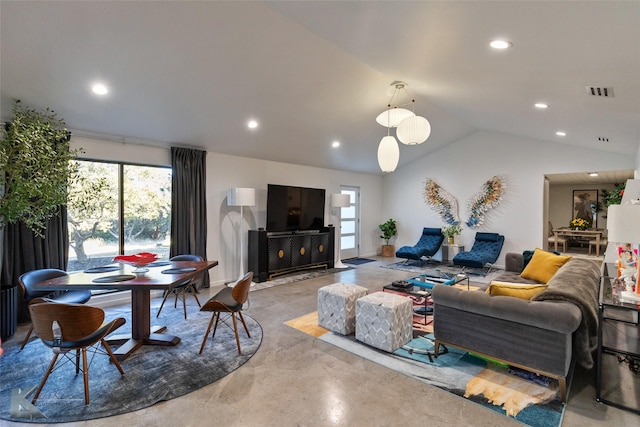 living room featuring concrete floors and vaulted ceiling