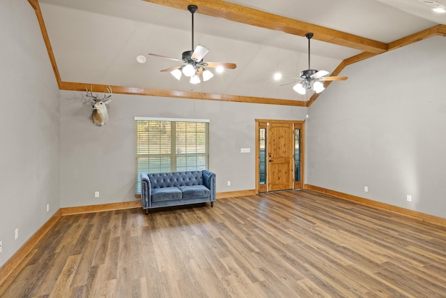 interior space featuring hardwood / wood-style flooring, ceiling fan, and lofted ceiling with beams