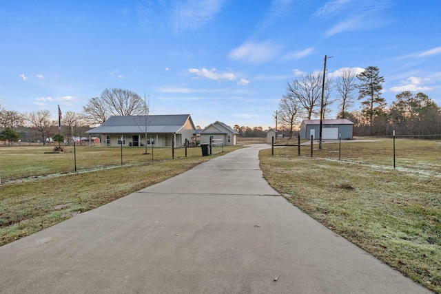 view of home's community with a yard and an outdoor structure