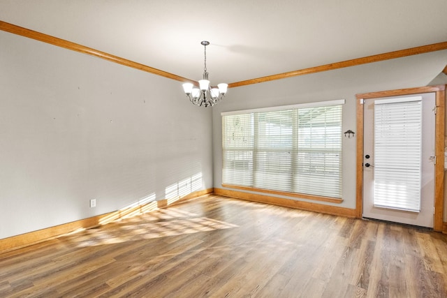 interior space featuring crown molding, hardwood / wood-style floors, and an inviting chandelier