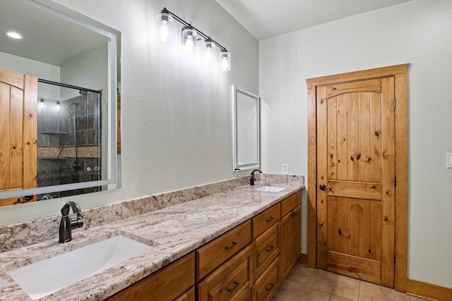 bathroom featuring tile patterned flooring, an enclosed shower, and vanity