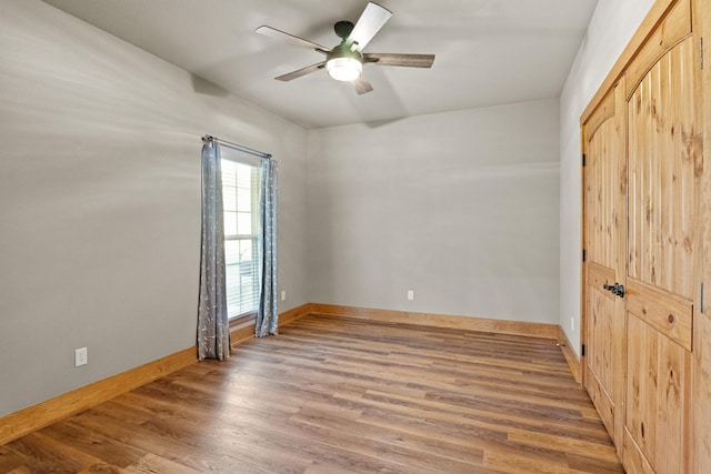 unfurnished room featuring hardwood / wood-style flooring and ceiling fan